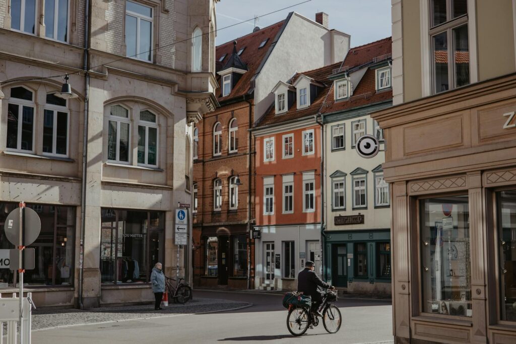 Quaint street scene in Erfurt, Germany, featuring historic architecture and a cyclist.